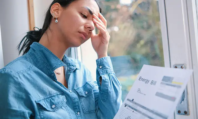 Woman in despair after looking at her energy bill