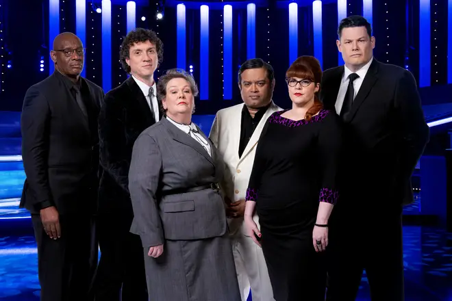 Paul Sinha is one of the Chasers on The Chase. Pictured here with Shaun Wallace, Darragh Ennis, Anne Hegerty, Jenny Ryan and Mark Labbett.
