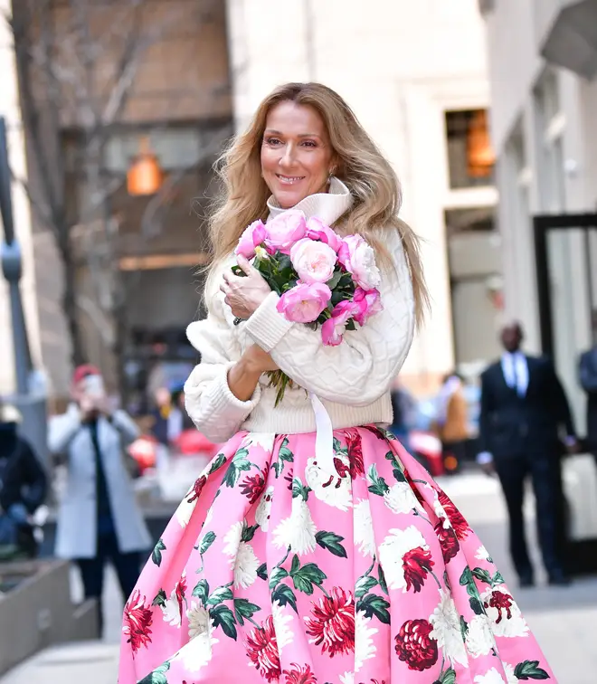 Celine Dion poses with a bunch of flowers