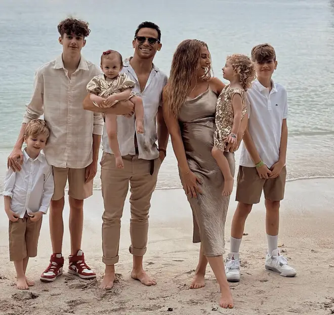 Stacey Solomon poses with her family on a beach