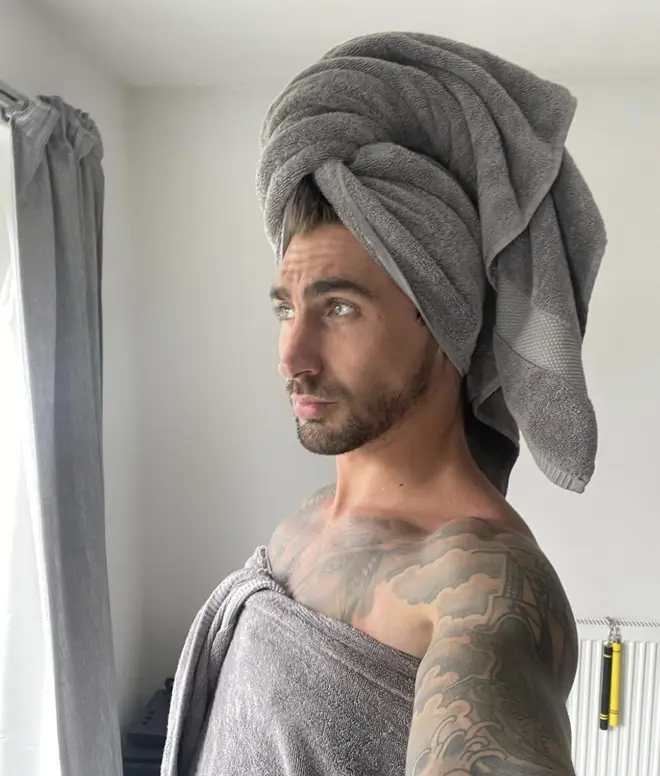 Chris Taylor poses in a towel