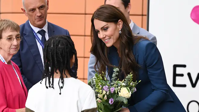 The Duchess of Cambridge taking flowers from a young child at a royal engagement