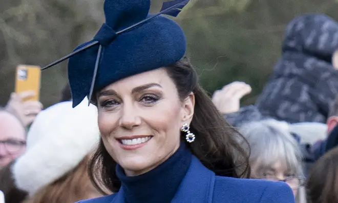Kate Middleton wearing blue hat and coat at a royal appearance