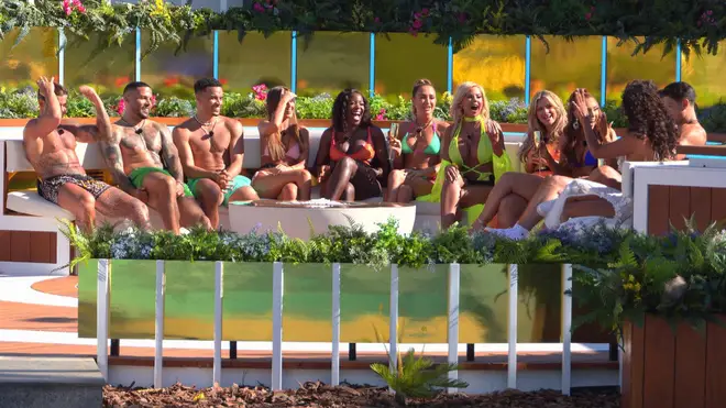 The Love Island All Stars sit at the fire pit 