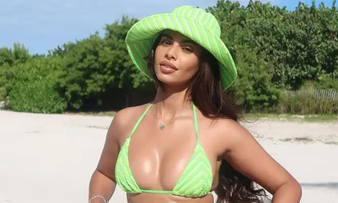 Sophie Piper in a lime green bikini on an exotic beach