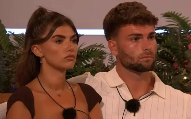 Tom Clare and Samie Elishi sit at the fire pit on Love Island