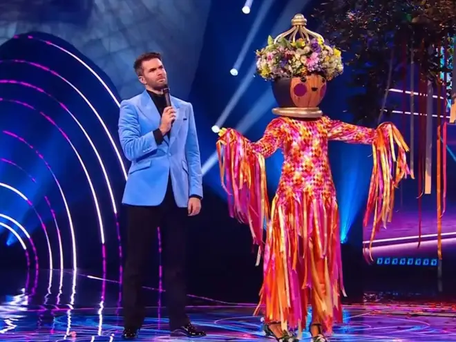 Maypole stands with Joel Dommett on The Masked Singer