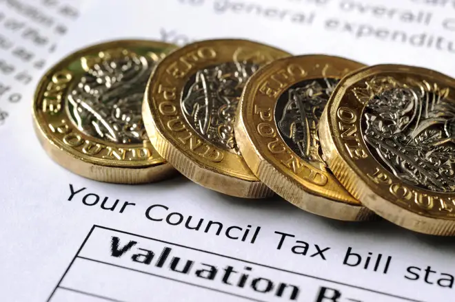 Pound coins rest on top of council tax bill