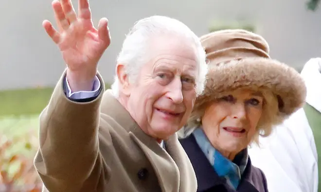 King Charles waving alongside wife Camilla
