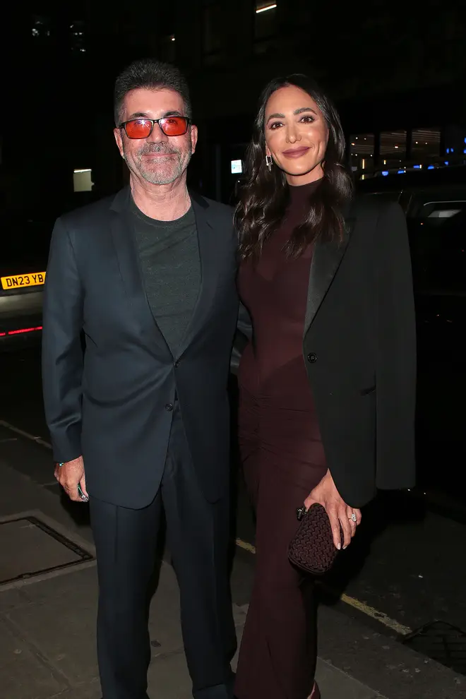 Simon Cowell has been seen with orange glasses recently. Pictured with his fiancé Lauren Silverman