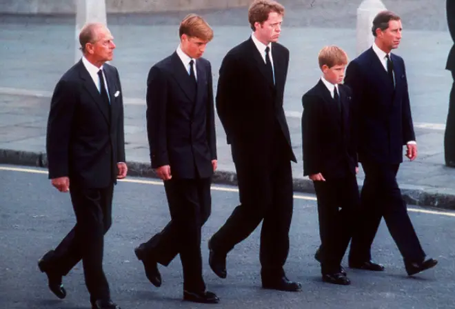 Princes William and Harry walk behind the coffin of their mother Princess Diana