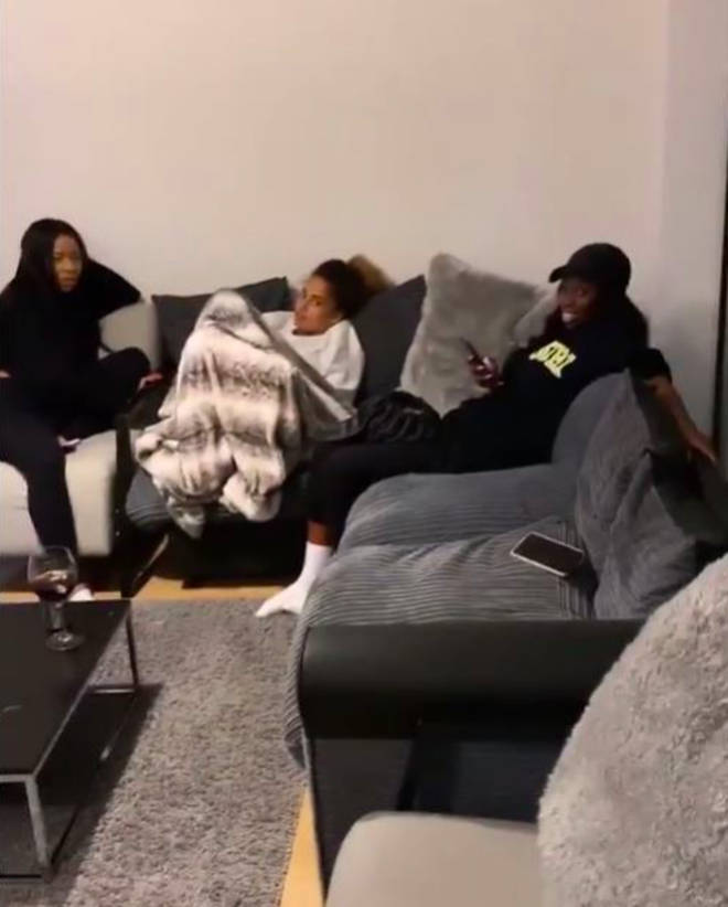 Amber Gill relaxes on he sofa with Yewande