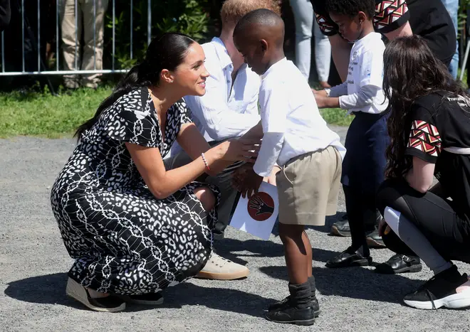 Meghan Markle embraced the children as they arrived in Cape Town
