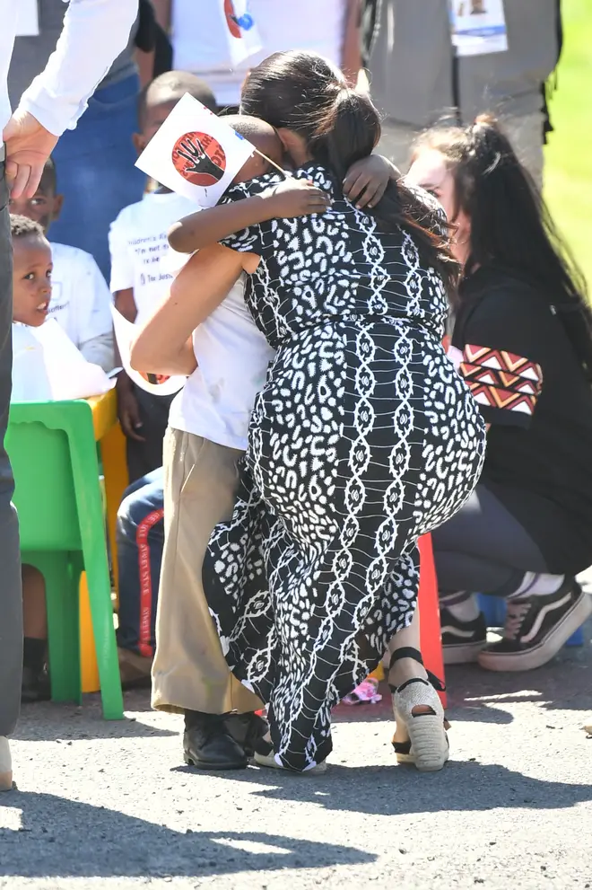 The Duchess of Sussex embraced one child with a hug