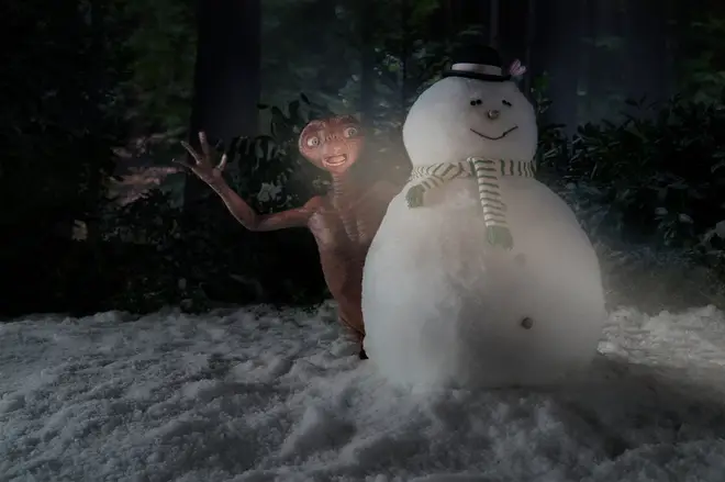 E.T. emerges from behind a snowman